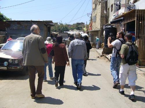 noam chomsky and entourage walking near chatila camp